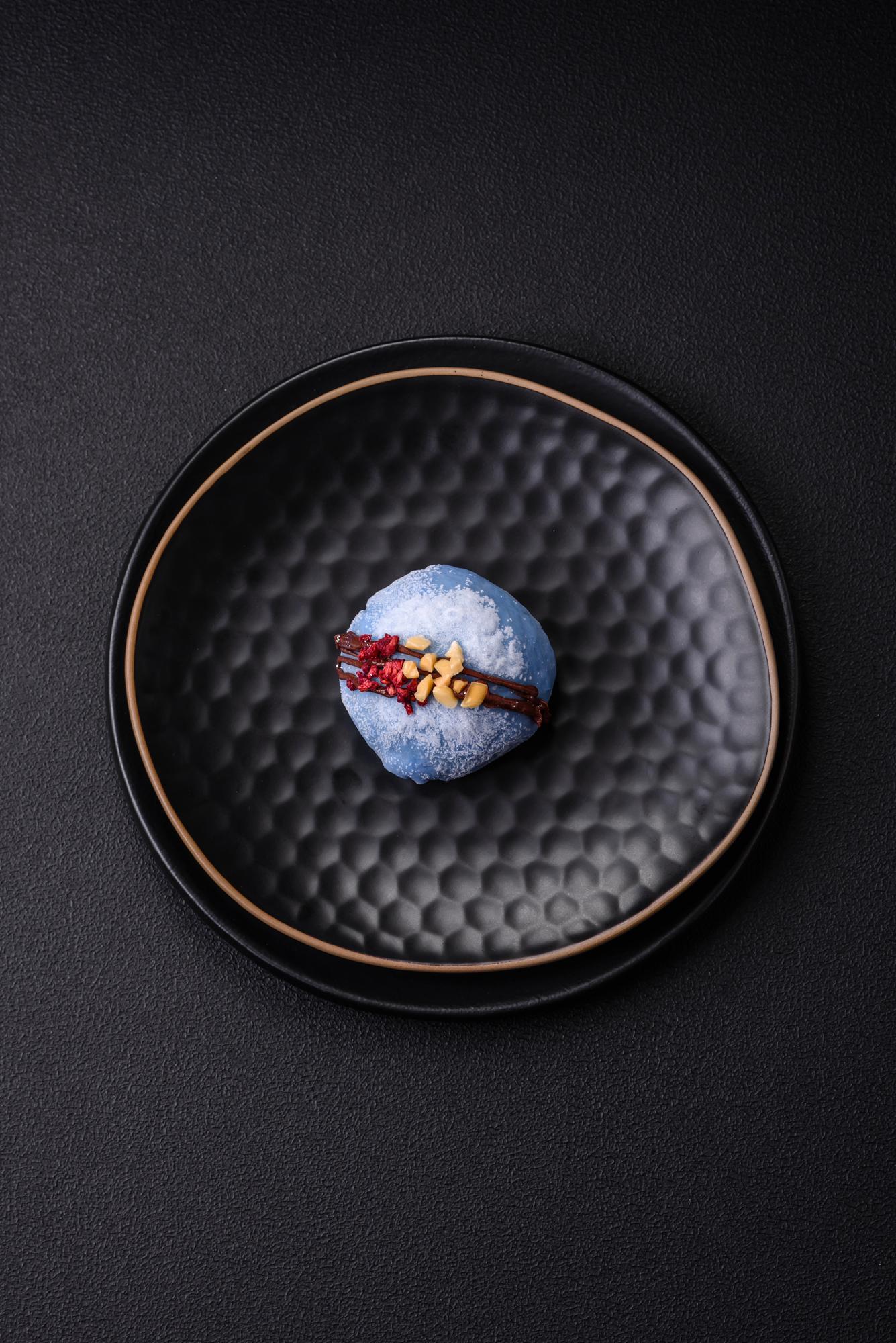 hand-plated gourmet dish on dark tabletop